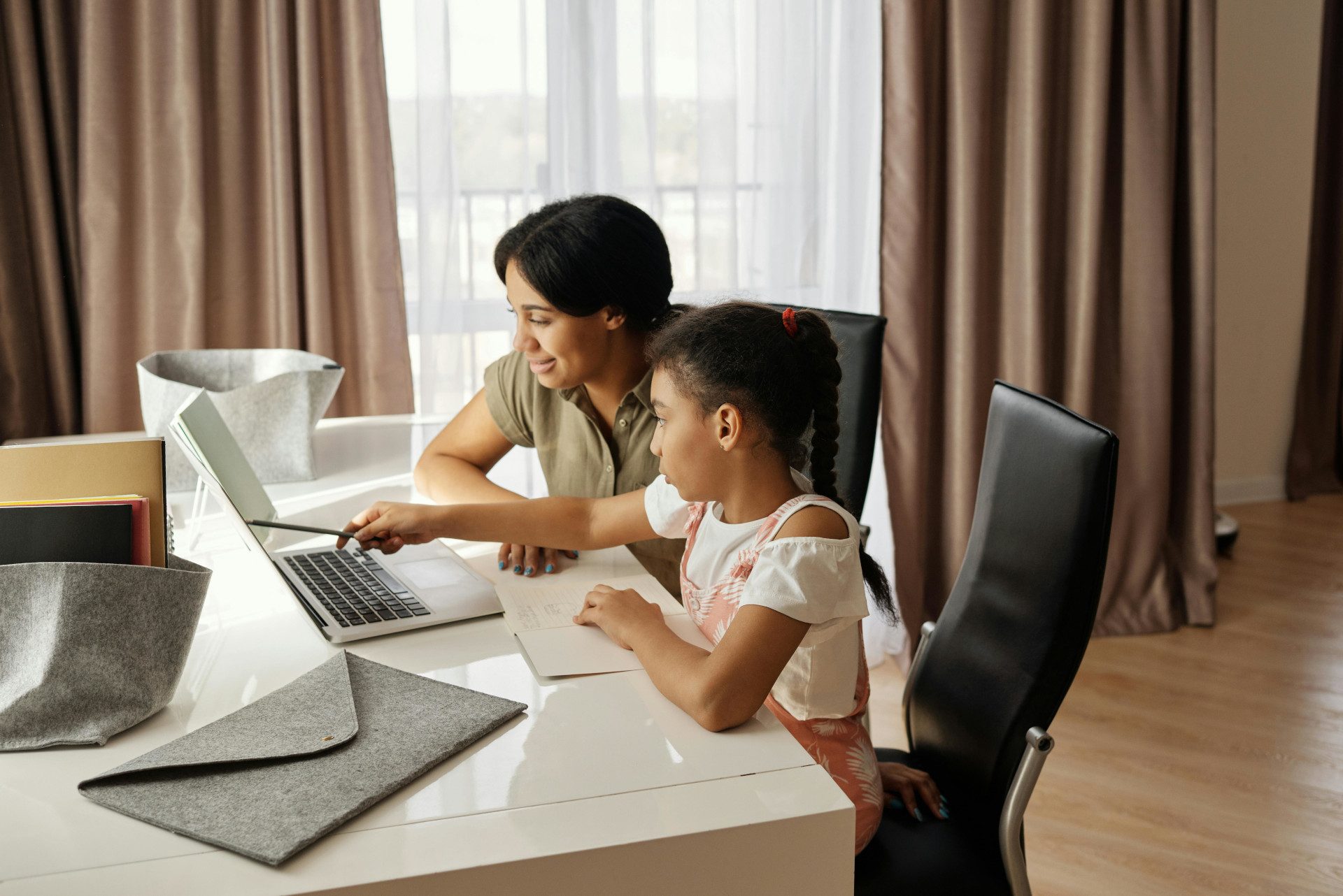 mother helping daughter with homework