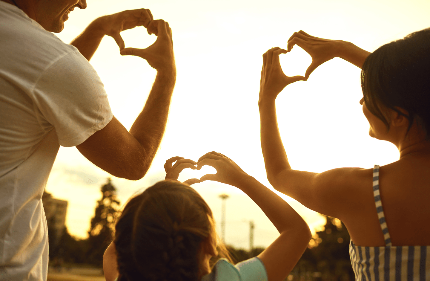 people making heart shapes with their hands